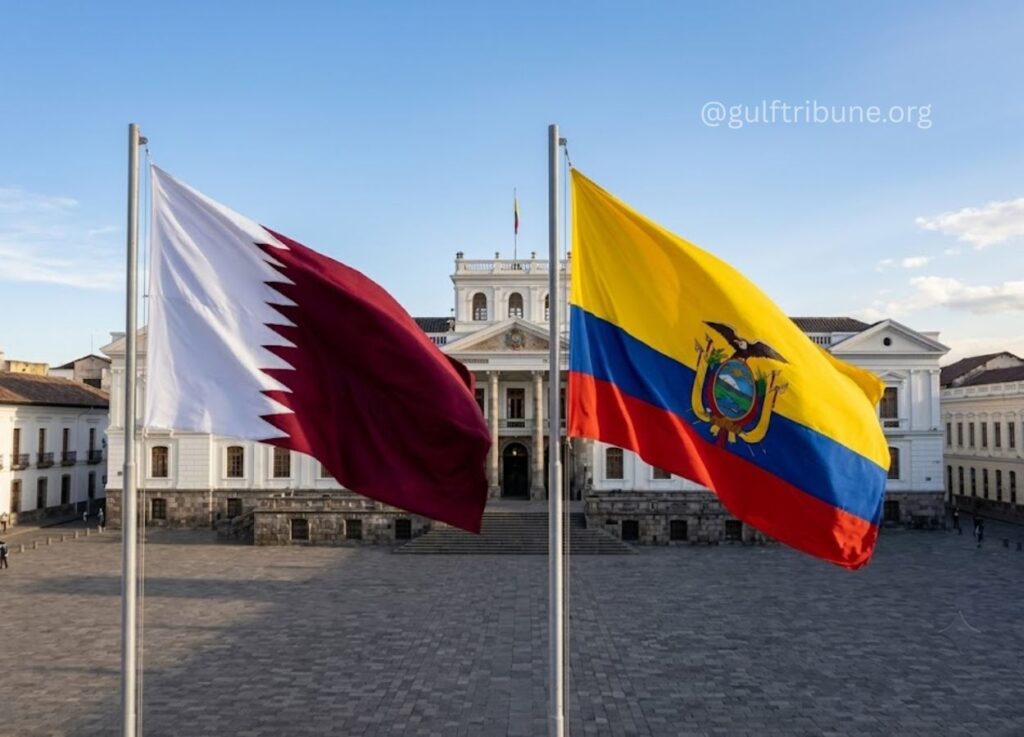 2 - Gulf Tribune Qatar and Colombia flags flutter in front of a neoclassical government building in a sunny plaza.